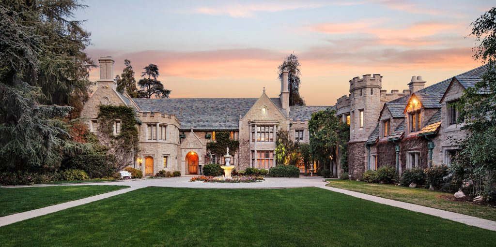 The playboy mansion pictured at dusk.